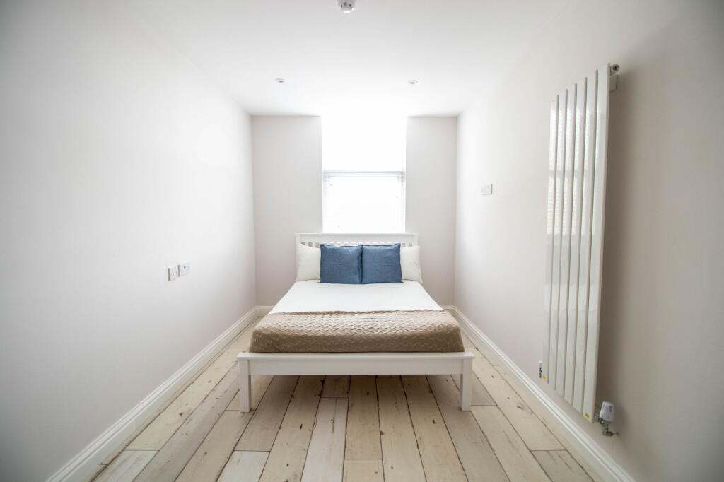Bright and spacious master bedroom featuring a ...