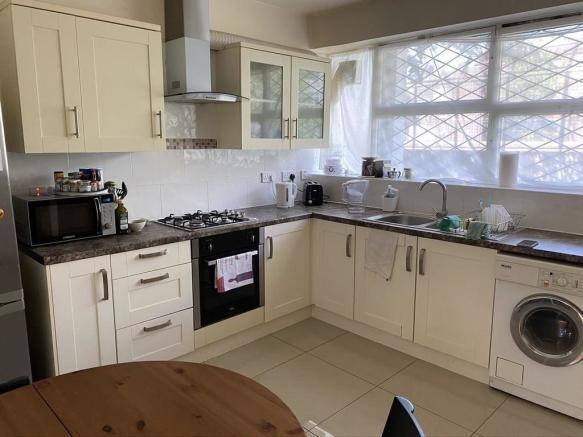 Bright and well-maintained kitchen featuring am...