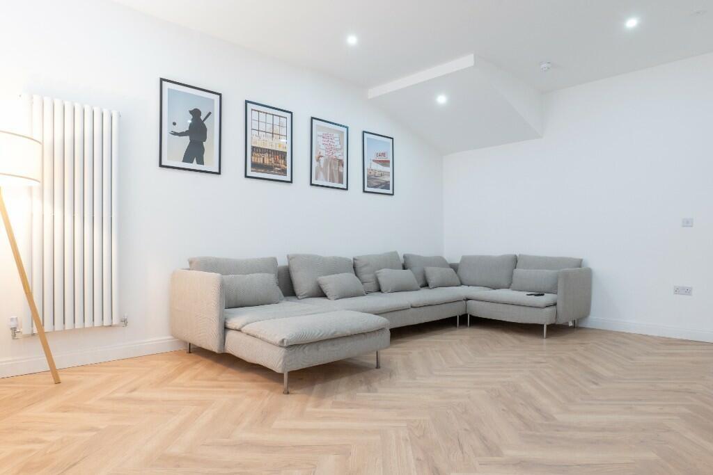 Bright and spacious living room featuring a mod...