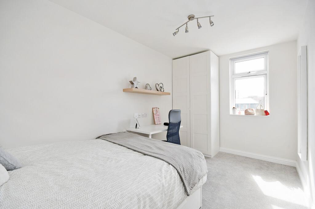 Bright and airy master bedroom with a large bed...