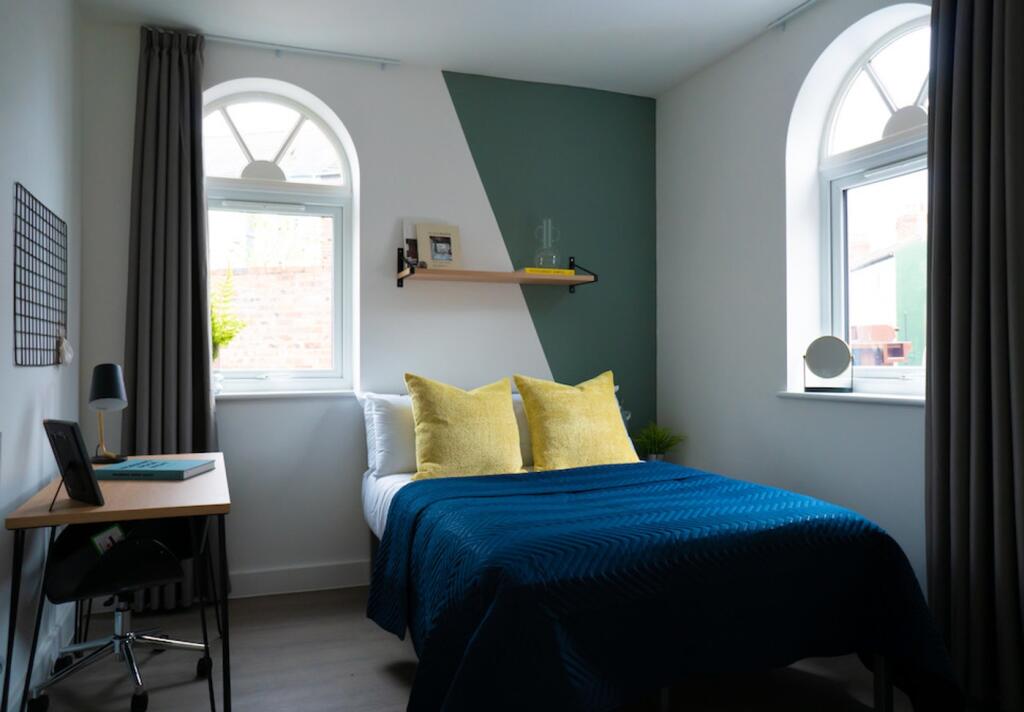 A stylish and well-lit double bedroom featuring...