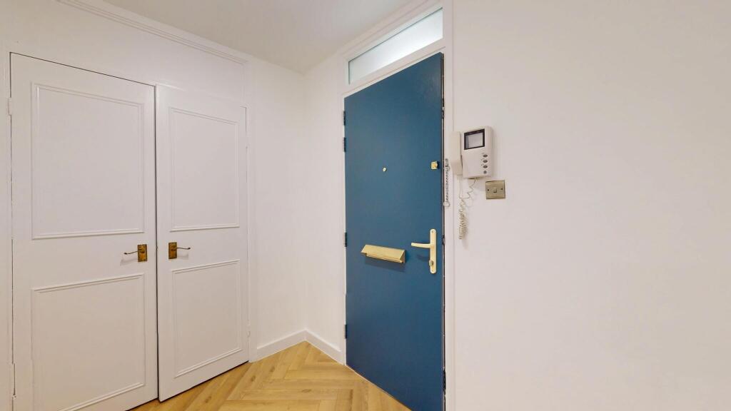 A bright and clean hallway featuring a bold blu...