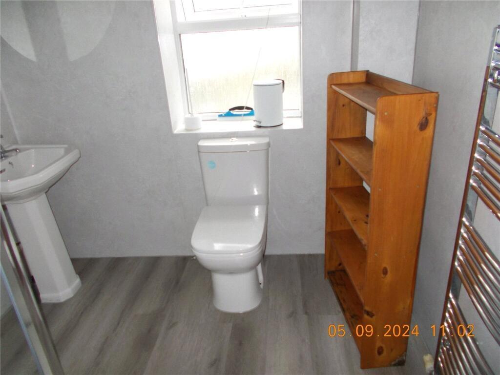 A clean and brightly lit bathroom featuring a m...