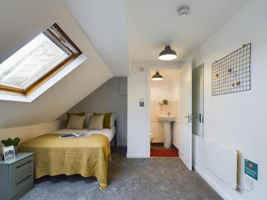 A charming and well-lit double bedroom with sty...