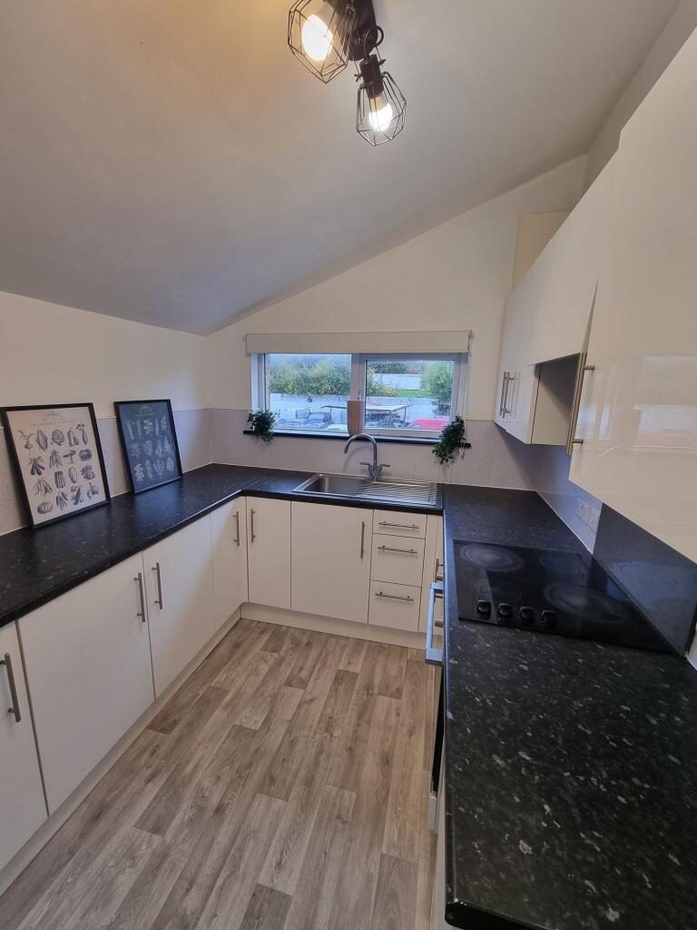 A modern, well-maintained kitchen featuring whi...