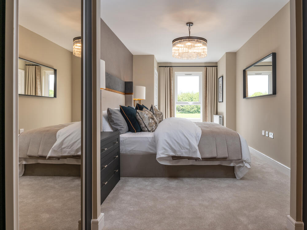 An image of the main bedroom with sliding wardrobe in a 2 bedroom apartment at Stonehaven Park
