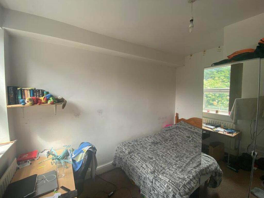 A cozy double bedroom with ample natural light,...