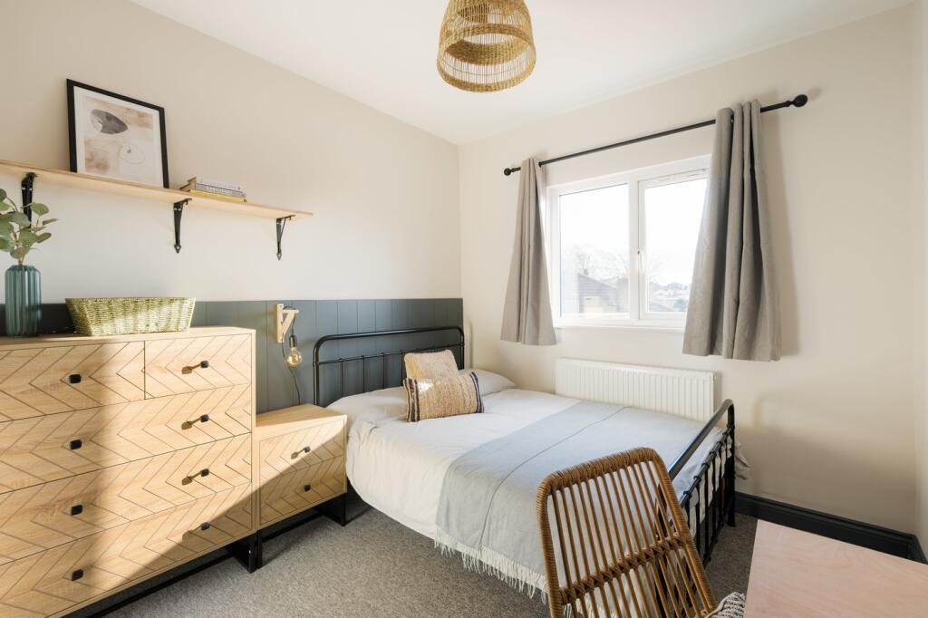 A stylish and well-lit double bedroom featuring...