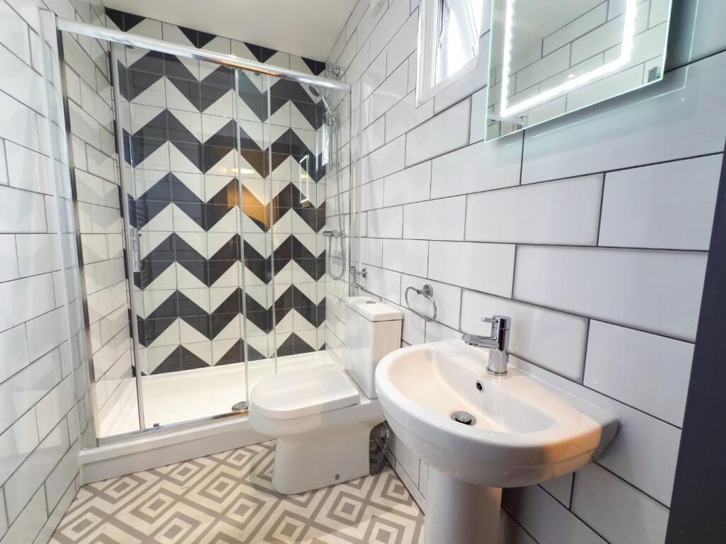 A modern bathroom featuring a white sink and a ...