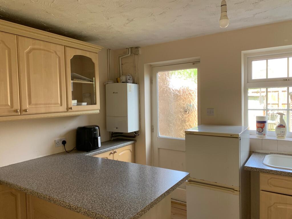 A bright and functional kitchen with ample stor...