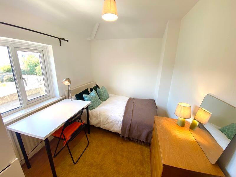 Bright and cozy double bedroom featuring a comf...