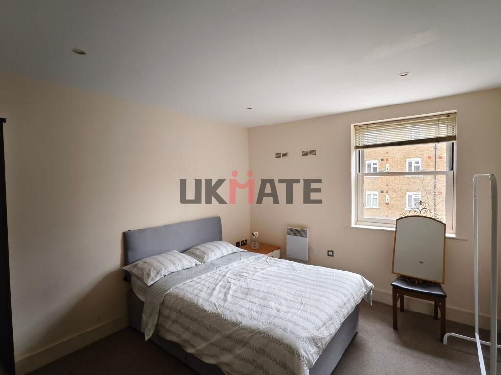 A bright and neatly maintained bedroom featurin...