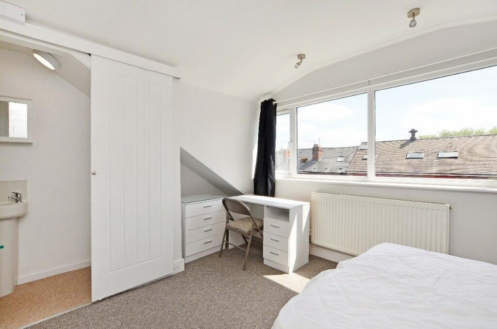 Bright and airy master bedroom featuring a larg...