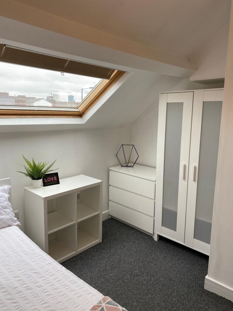 A bright and inviting double bedroom featuring ...