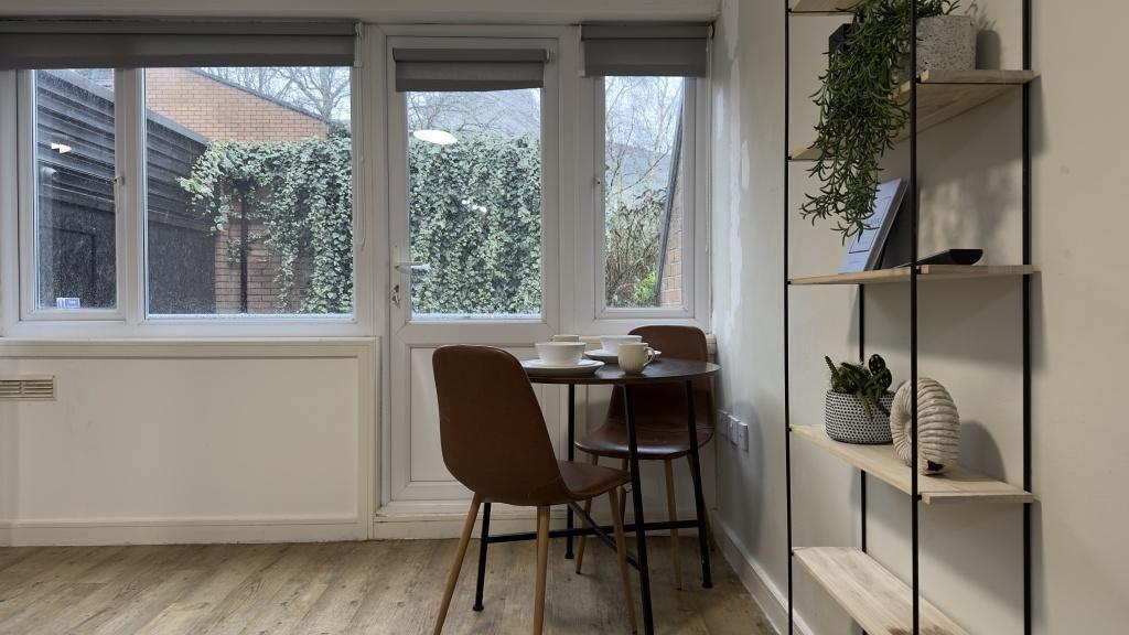 Bright and inviting communal workspace featurin...