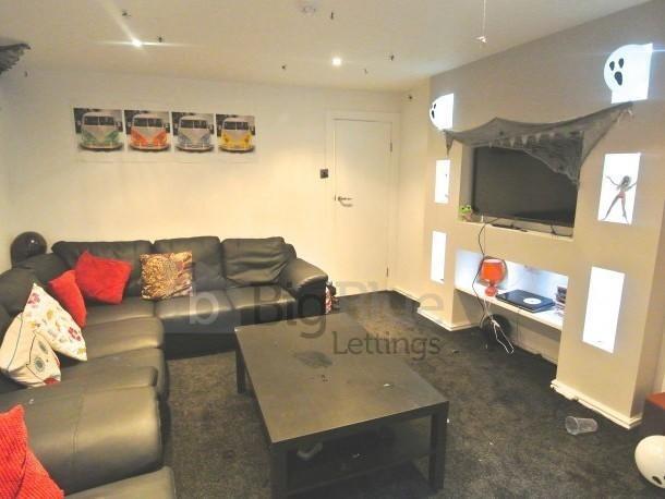Contemporary living room featuring a large, com...