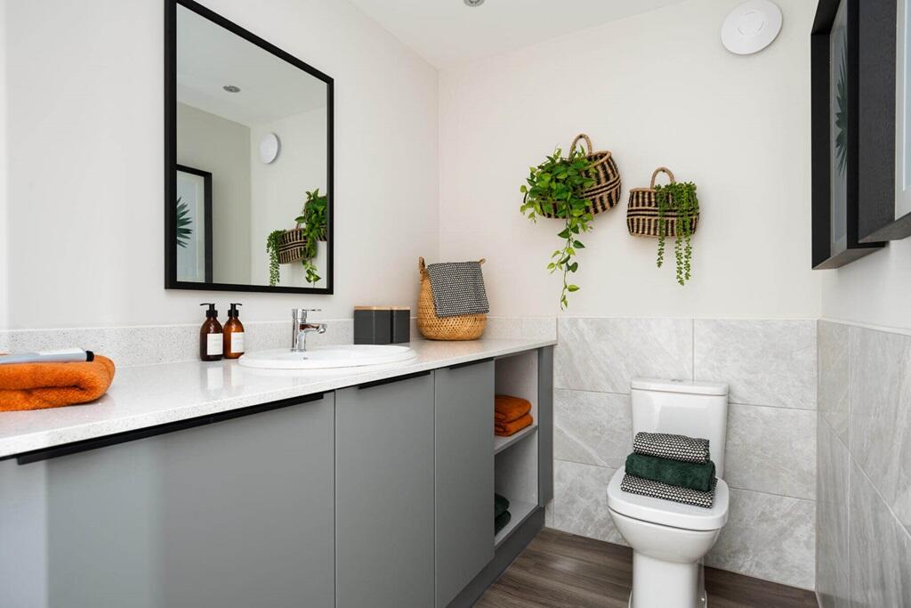 A guest cloakroom also hosts space for laundry appliances