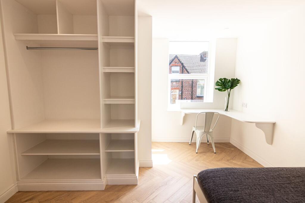 Bright and airy room with a large window allowi...