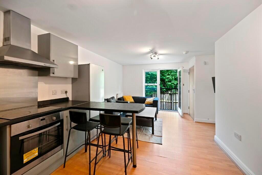 Modern kitchen area with sleek appliances, a br...