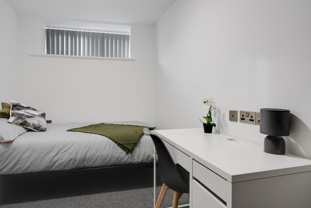 This inviting double bedroom features a comfort...