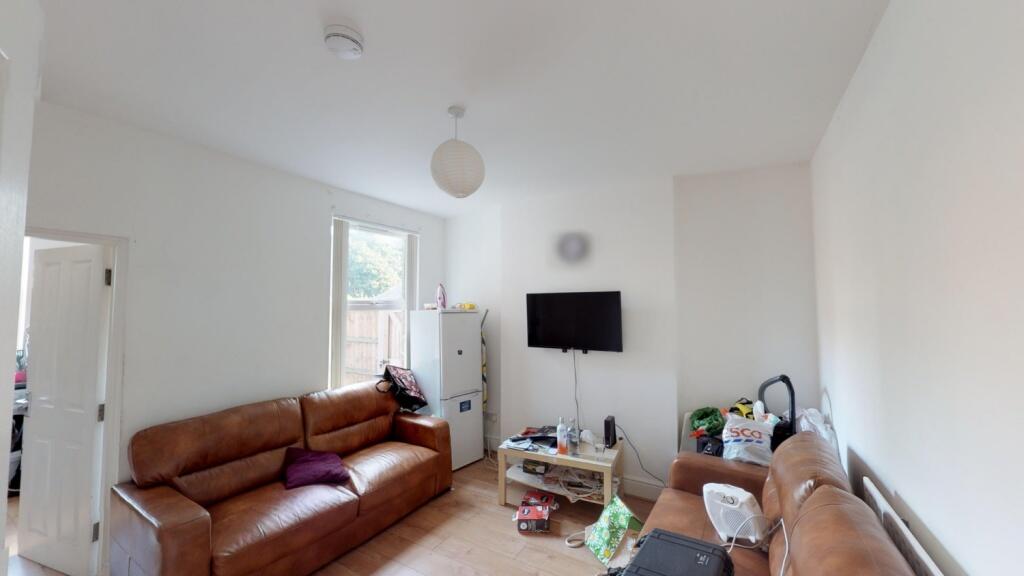 Cozy living room featuring comfortable brown le...