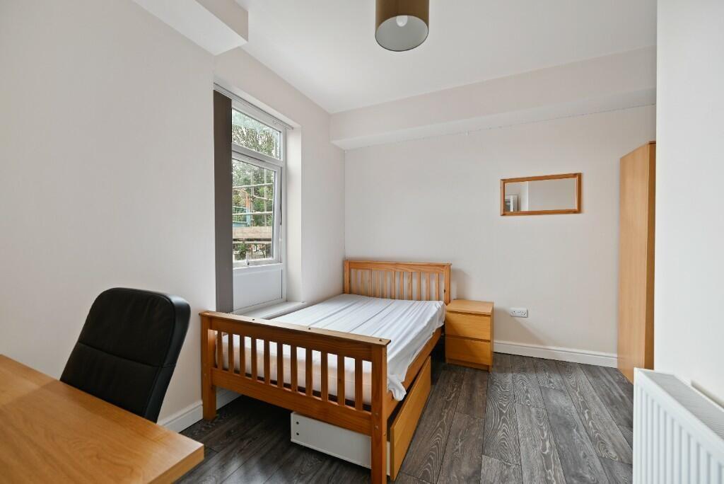 Bright and cozy bedroom featuring a wooden sing...