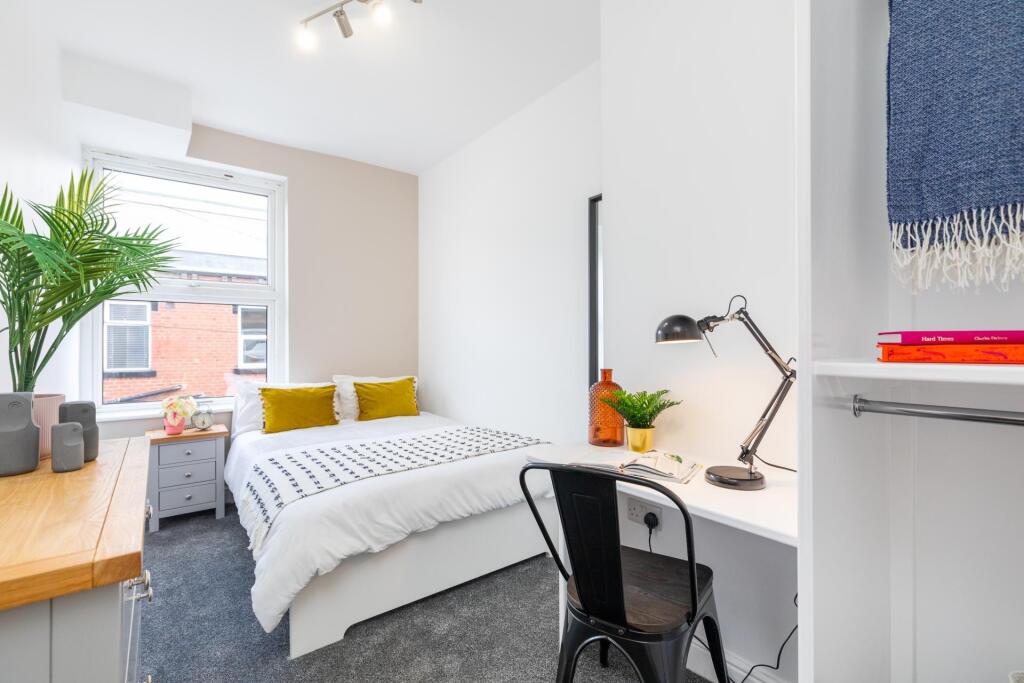 A bright and modern bedroom featuring a double ...