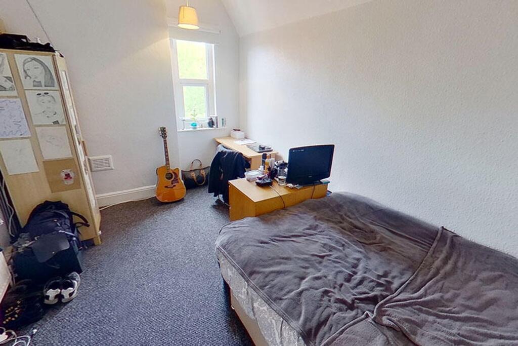 Cozy double bedroom featuring ample natural lig...