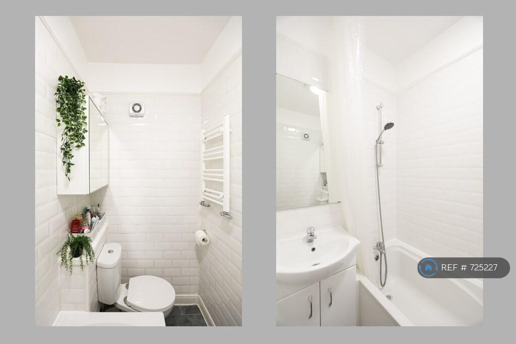 a Clean White Bathroom Suite And Storage