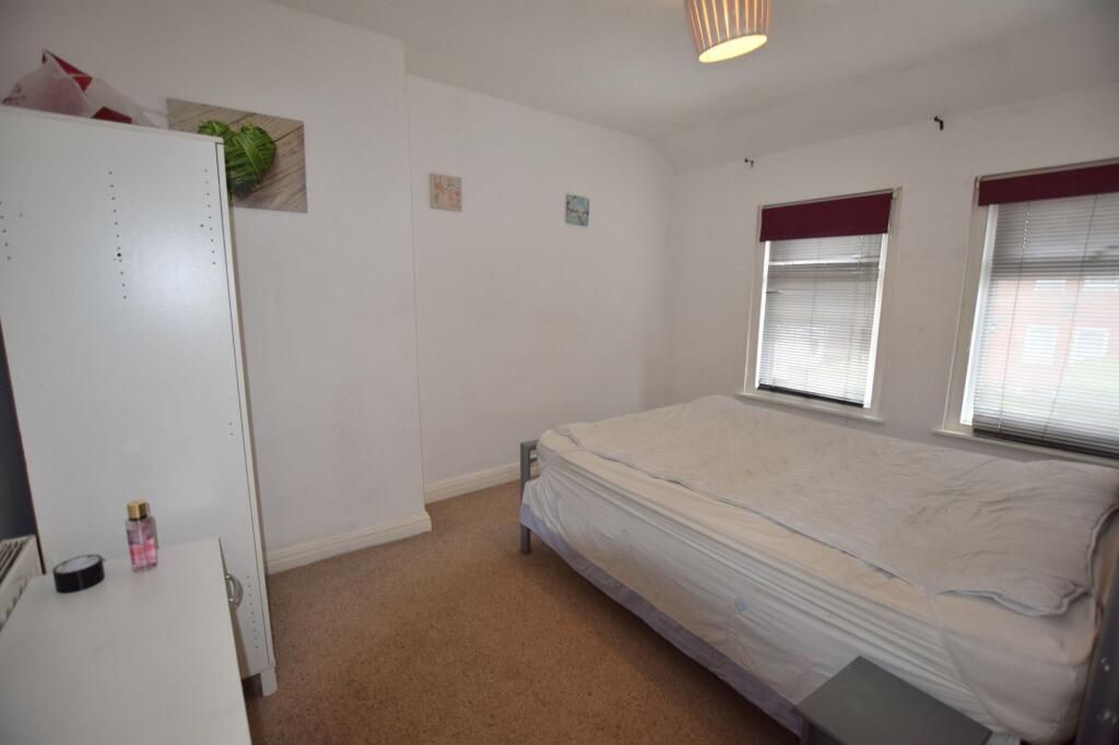 A cozy double bedroom featuring a comfortable b...