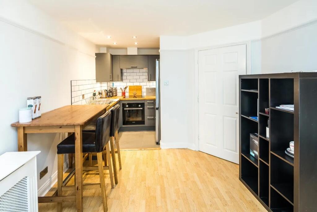Bright and modern kitchen space featuring sleek...