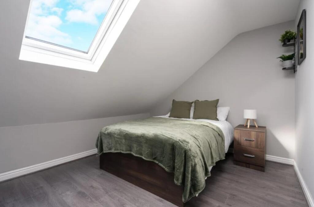 Cozy double bedroom featuring a comfortable bed...