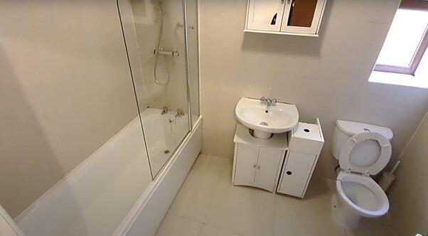 A bright and clean bathroom featuring a shower ...
