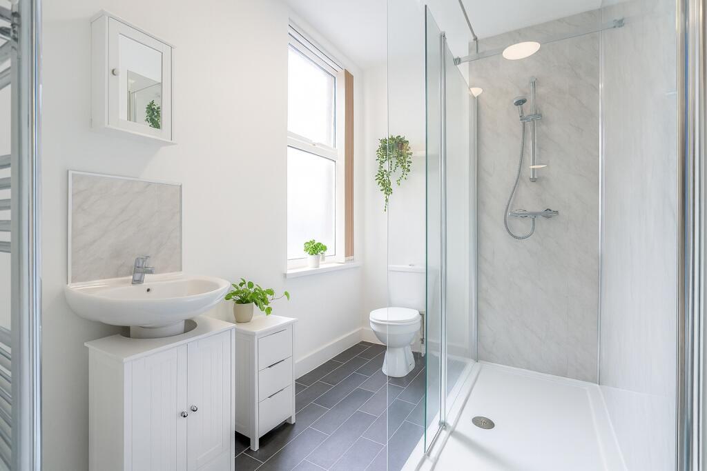 Bright and modern bathroom featuring a large wa...
