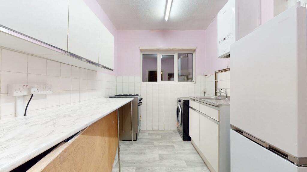 Bright and modern kitchen featuring ample count...