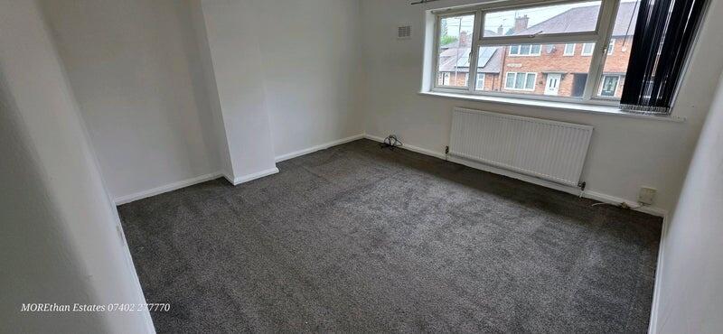 Bright and spacious living room with large wind...