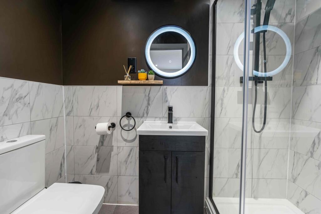 Modern bathroom featuring a sleek vanity with a...