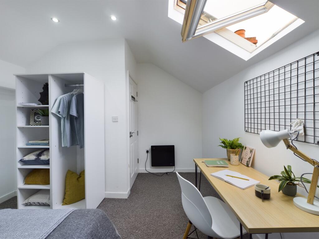 A spacious and well-lit large double bedroom, p...