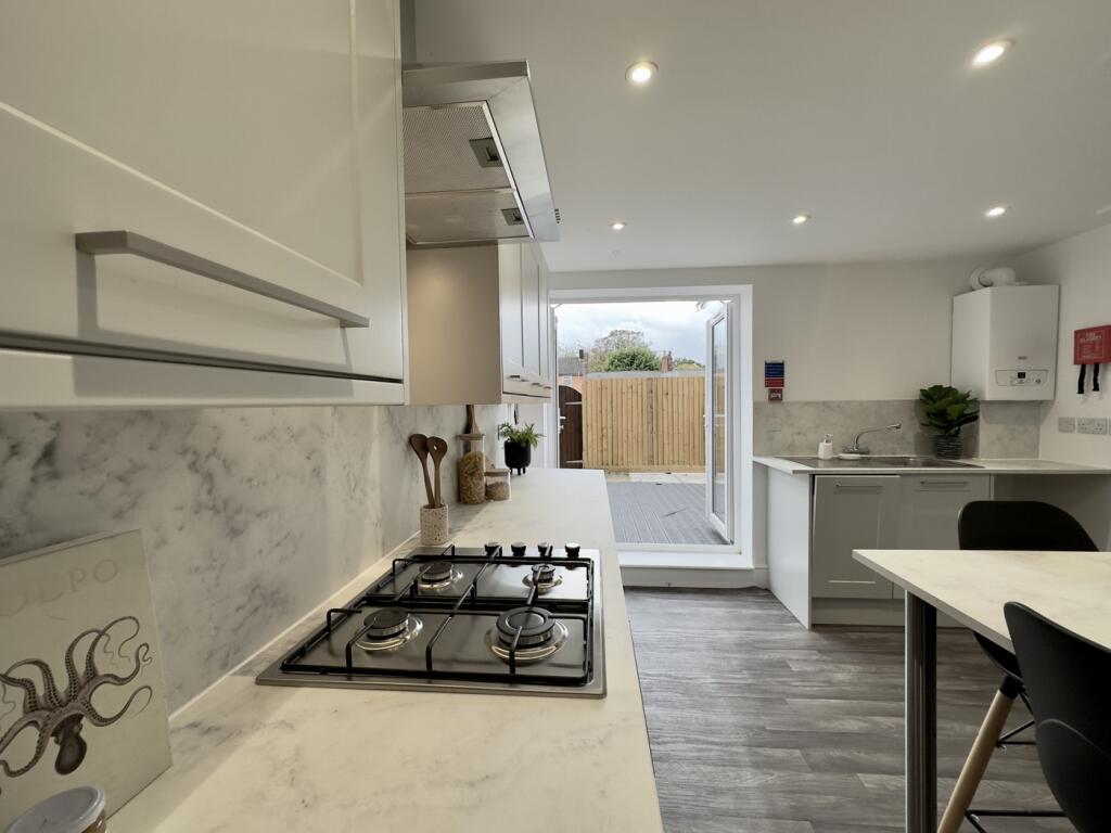 A bright and modern kitchen with a stylish desi...