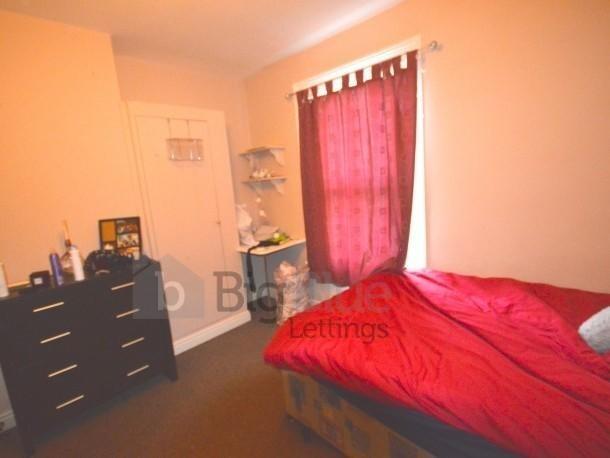 Cozy single bedroom featuring a comfortable bed...