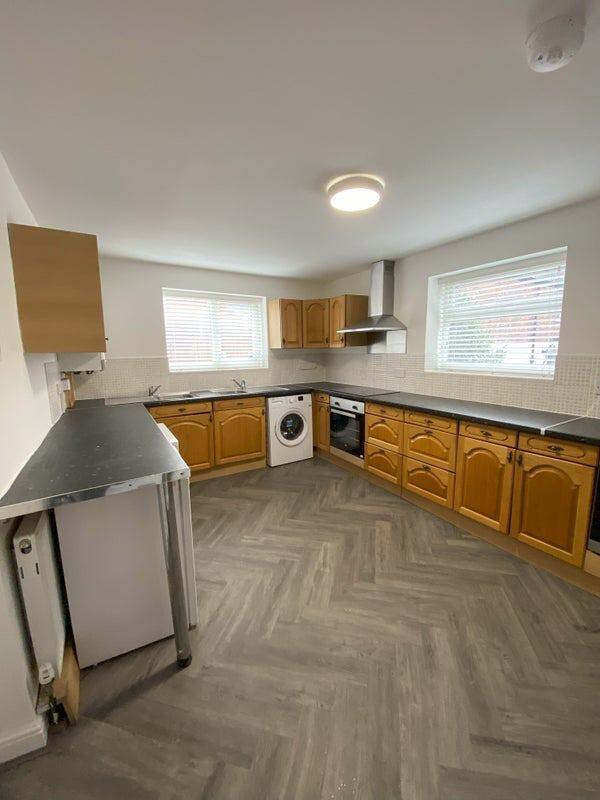 Bright and spacious kitchen featuring ample cou...