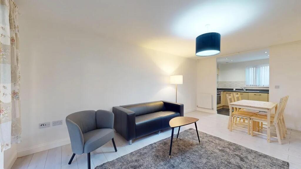 Bright and modern living room featuring a comfo...