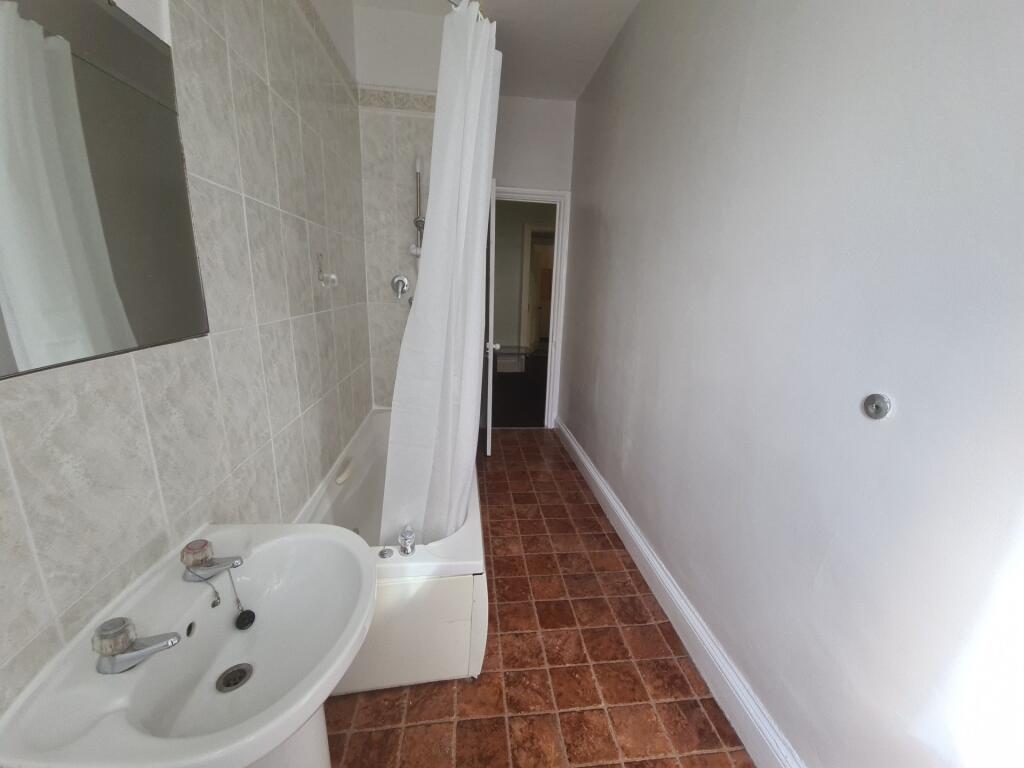 A clean and well-maintained bathroom with a sho...