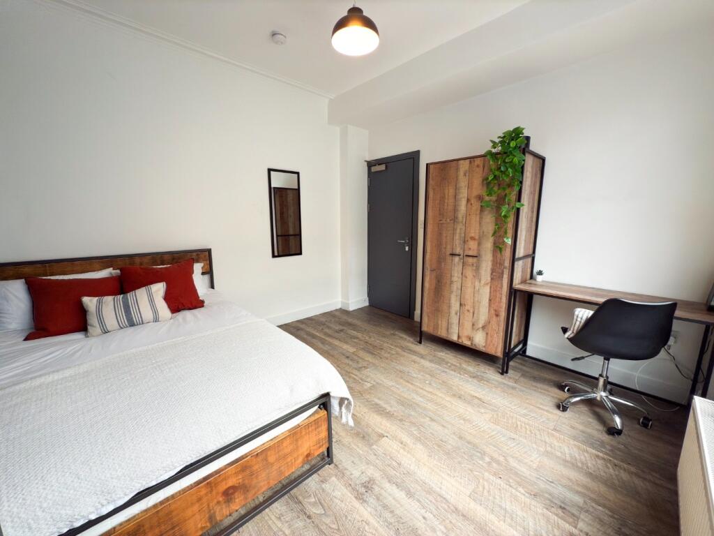 Bright and spacious master bedroom featuring a ...