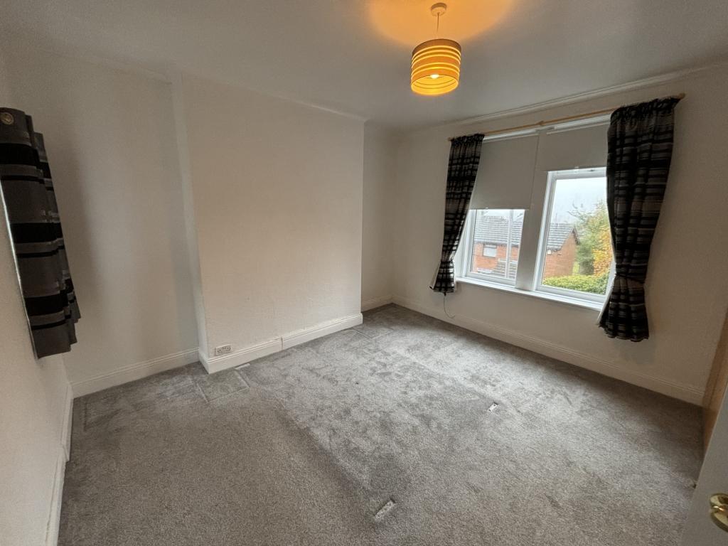 A bright and clean double bedroom featuring two...