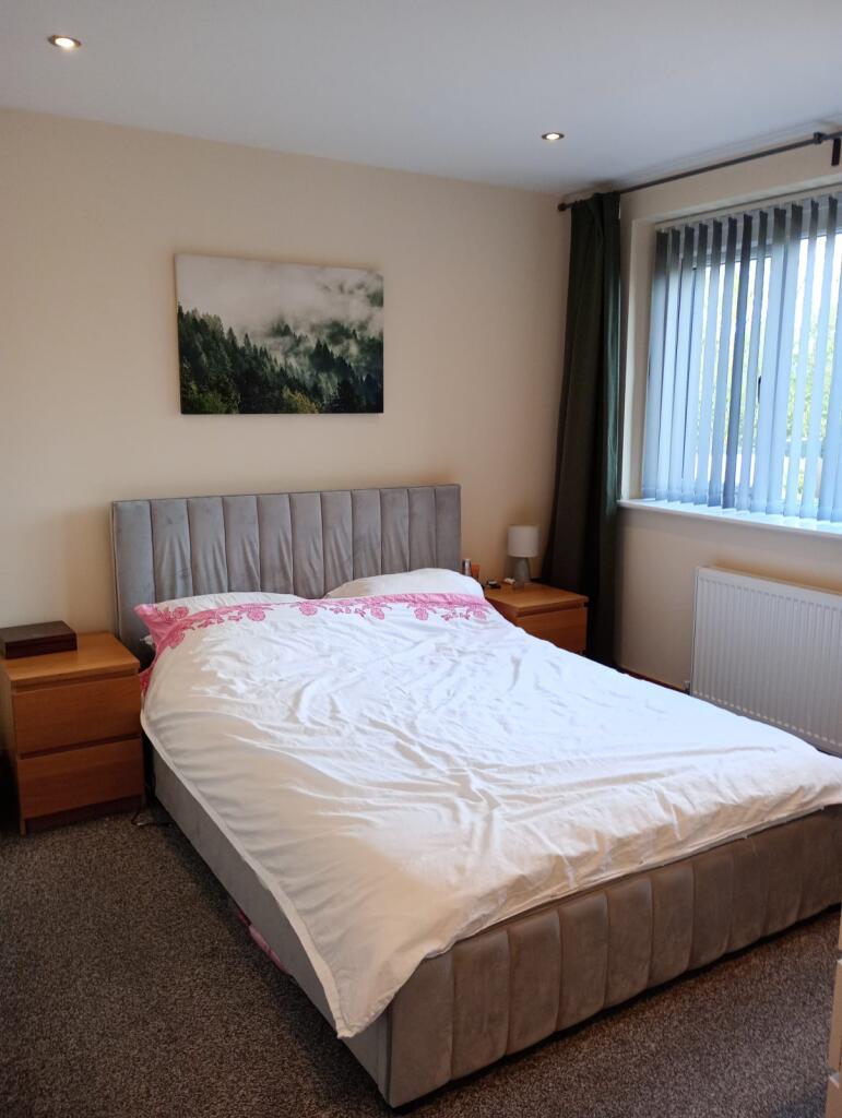 A cozy and well-kept double bedroom featuring a...