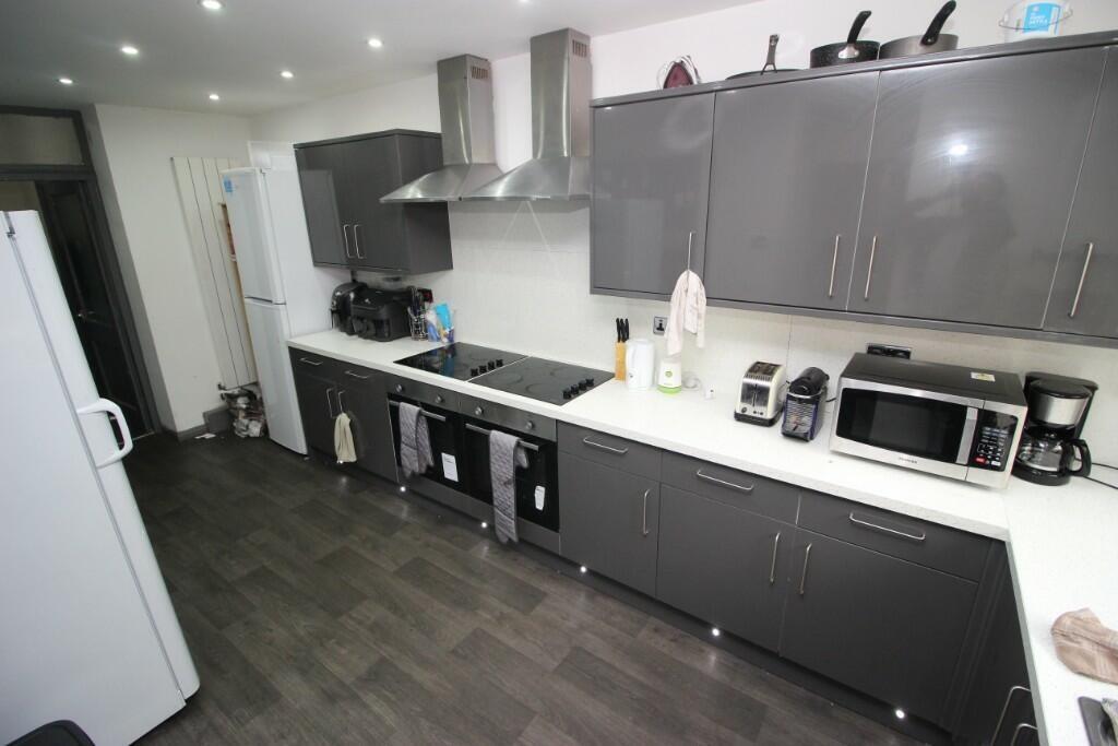 A sleek, modern kitchen featuring ample cabinet...