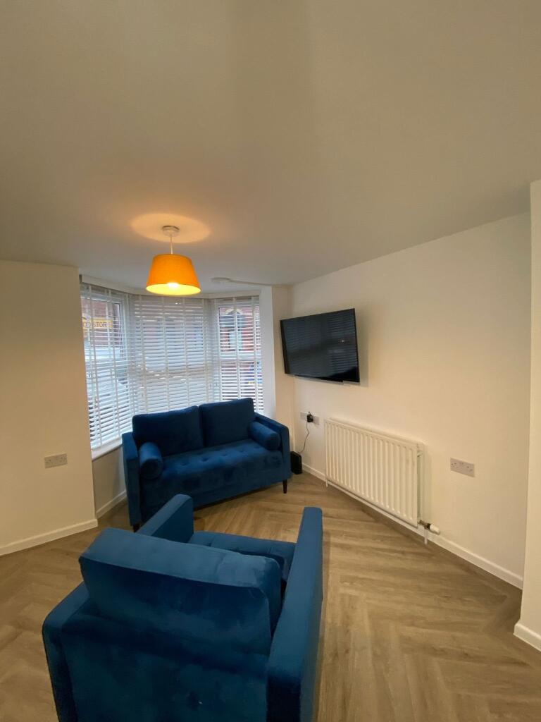 A bright, modern living room featuring a large ...