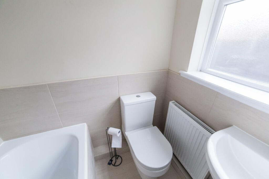 Bright and modern bathroom featuring a spacious...
