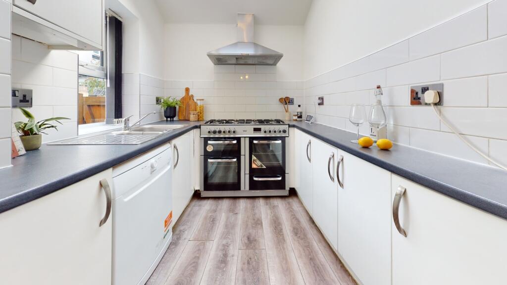 A bright and modern kitchen with ample space an...